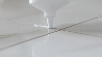Close-Up of Grout Application Between White Ceramic Tiles video