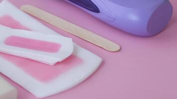Aesthetic Waxing Kit featuring Applicator and Strips set on a Pink Background video
