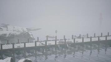 Snow-Covered Dock in Cold Norwegian Lake video