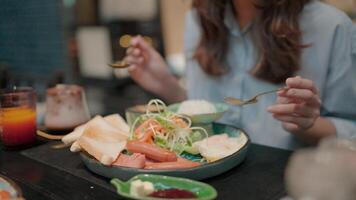 Delicious Breakfast A young woman is enjoying a delicious and colorful breakfast, enjoying every bite of food in a warm and intimate setting. The image evokes a sense of warmth and comfort. video