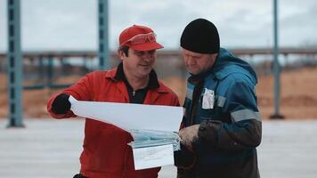 Professional foreman and construction manager talking - discussing about building structure plant together. video
