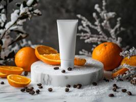 White cosmetic tube on white podium surrounded with snow, oranges, orange peels, coffee beans on marble table. Minimalistic photo style.