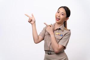 Young Thai Asian Teacher in the uniform is pointing to the empty copy space. photo
