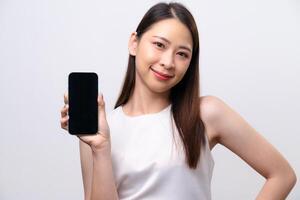 A woman is holding a cell phone in her hand and smiling photo