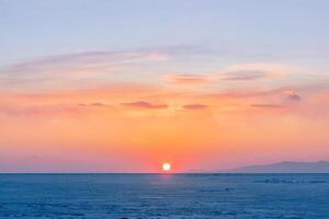 Winter landscape. A frozen surface of ice with snow intersected by many cracks. photo