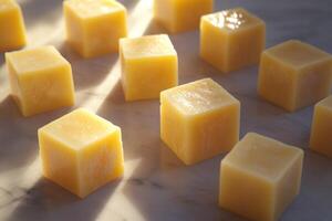 Yellow Cubes on a Marble Surface with Sunlight photo