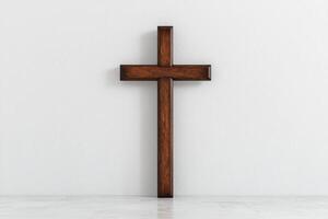 Wooden cross on white background photo