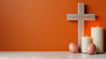 religious cross and candles on orange background photo