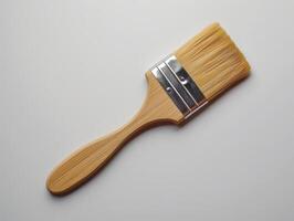 Paintbrush with wooden handle on white background photo