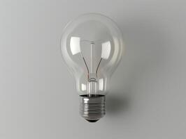 Glowing light bulb against a gray background photo