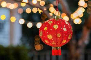 Vibrant red and gold chinese lantern with blurred lights background photo