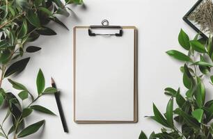 Minimalist office desk with clipboard and greenery photo