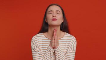 Young woman sincerely praying to God forgive me begging apology, asking for help pleading expression video