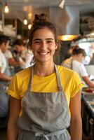 Smiling woman in apron working in cafe photo