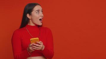 Girl using smartphone pointing empty place, positive feedback recommends social networks application video