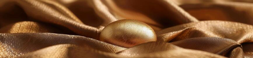 Golden egg nestled in luxurious golden fabric photo