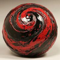 Abstract red and black swirl design on spherical object photo