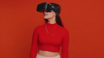 Young woman using virtual reality headset helmet to play simulation game app, watching content video