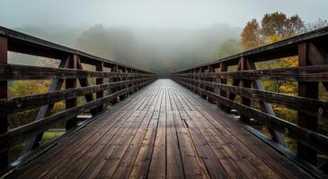 Misty Wooden Bridge Leading into Autumn Forest photo