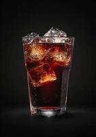 Refreshing glass of cola with ice on a dark background photo