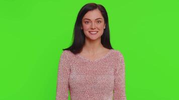 Woman pointing to camera, looking with playful happy expression, making choice, showing direction video