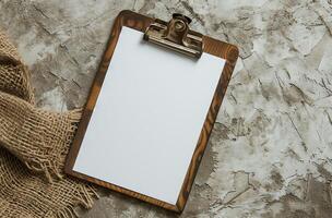 Blank clipboard on a textured background with burlap fabric photo