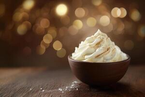 Creamy dessert topped with spices in a rustic bowl against a warm bokeh background photo
