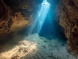 Sunlight streaming through an underwater cave photo