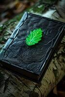 Artistic leather journal with embossed leaf design on a rustic background photo
