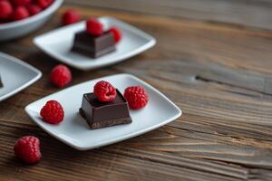 Dark Chocolate Pieces with Fresh Raspberries on Wooden Background photo