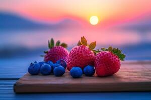 Fresh berries on a wooden board at sunset photo