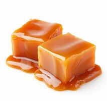 Caramel cubes with dripping sauce on white background photo