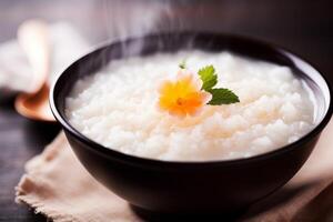 Steaming hot bowl of rice porridge with a flower garnish photo