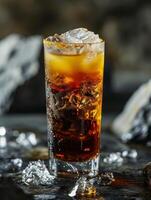 Iced cold soda in a tall glass with a dark background photo