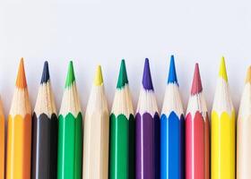 Colorful pencils lined up against a white background photo