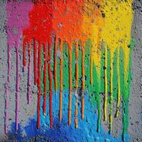 Colorful paint splatters on a concrete wall photo