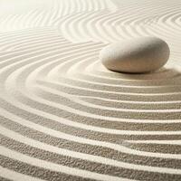 Zen stone on raked sand with circular patterns photo