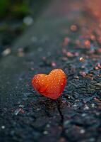 Heart shaped object on wet pavement with sparkling bokeh photo