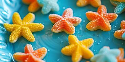 Colorful Gummy Starfish Candies on a Blue Background photo