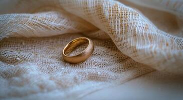Golden wedding ring on elegant fabric photo