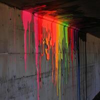 Colorful paint dripping on concrete wall under bridge photo