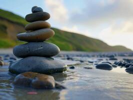 Zen stones stacked on a serene beach at sunset photo