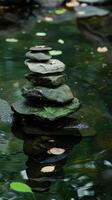 Zen stones stacked in a tranquil pond photo