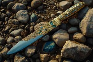 Ornate dagger on a rocky surface photo