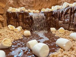 Delicious chocolate waterfall in a dessert landscape photo