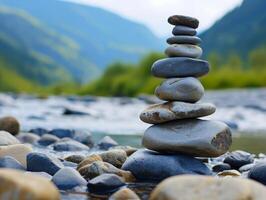 Zen stones stacked by a tranquil river in a mountain valley photo