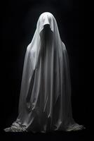 Mysterious figure shrouded in a white sheet against a dark background photo