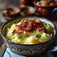 a bowl of mashed potatoes with bacon and green onions photo