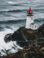 a lighthouse on a cliff by the ocean photo