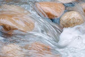 flowing water over rocks in a stream photo